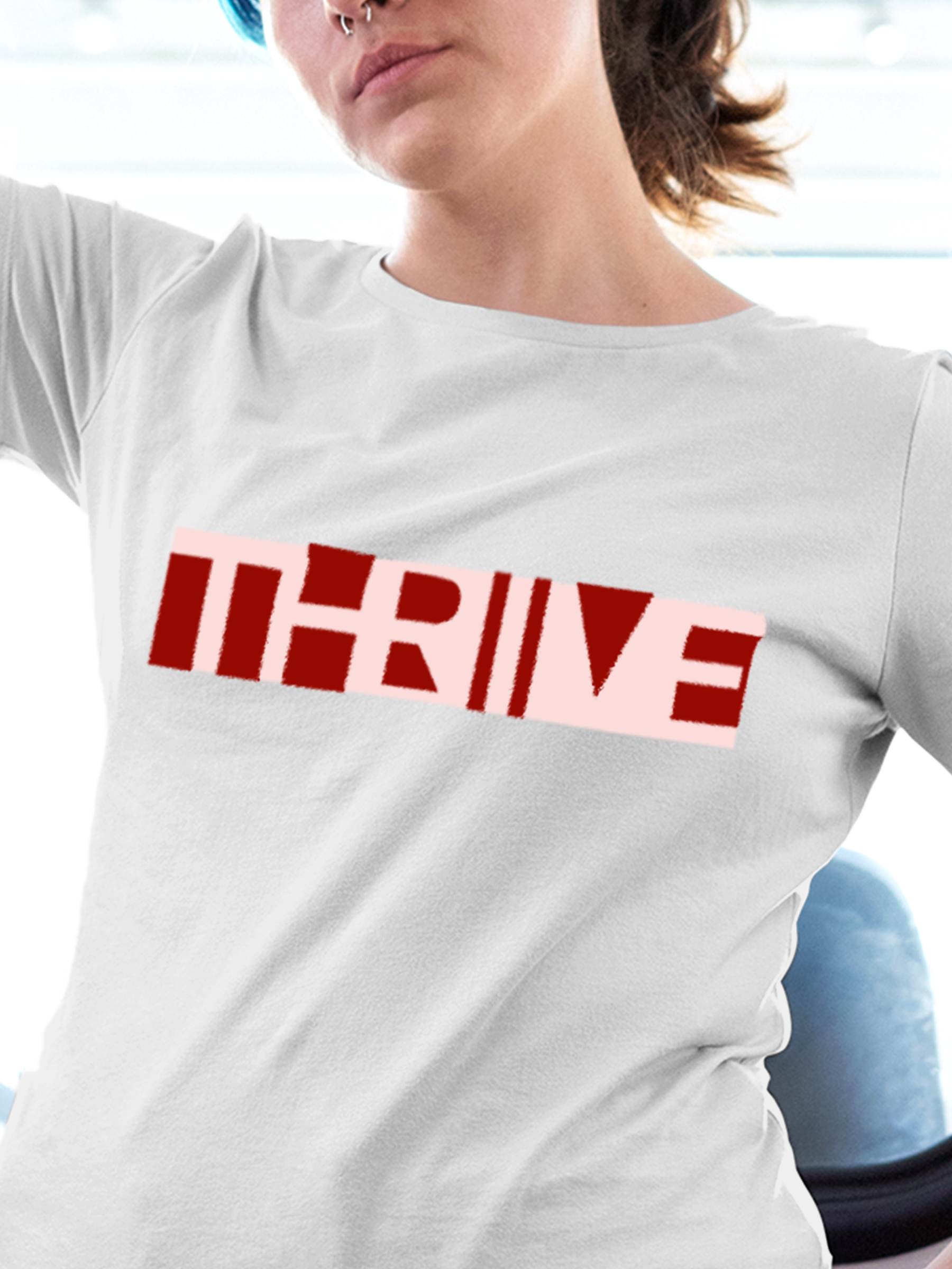 Close up of 'Thrive' design on Women's White Round Neck T-shirt, highlighting intricate details and vibrant print.