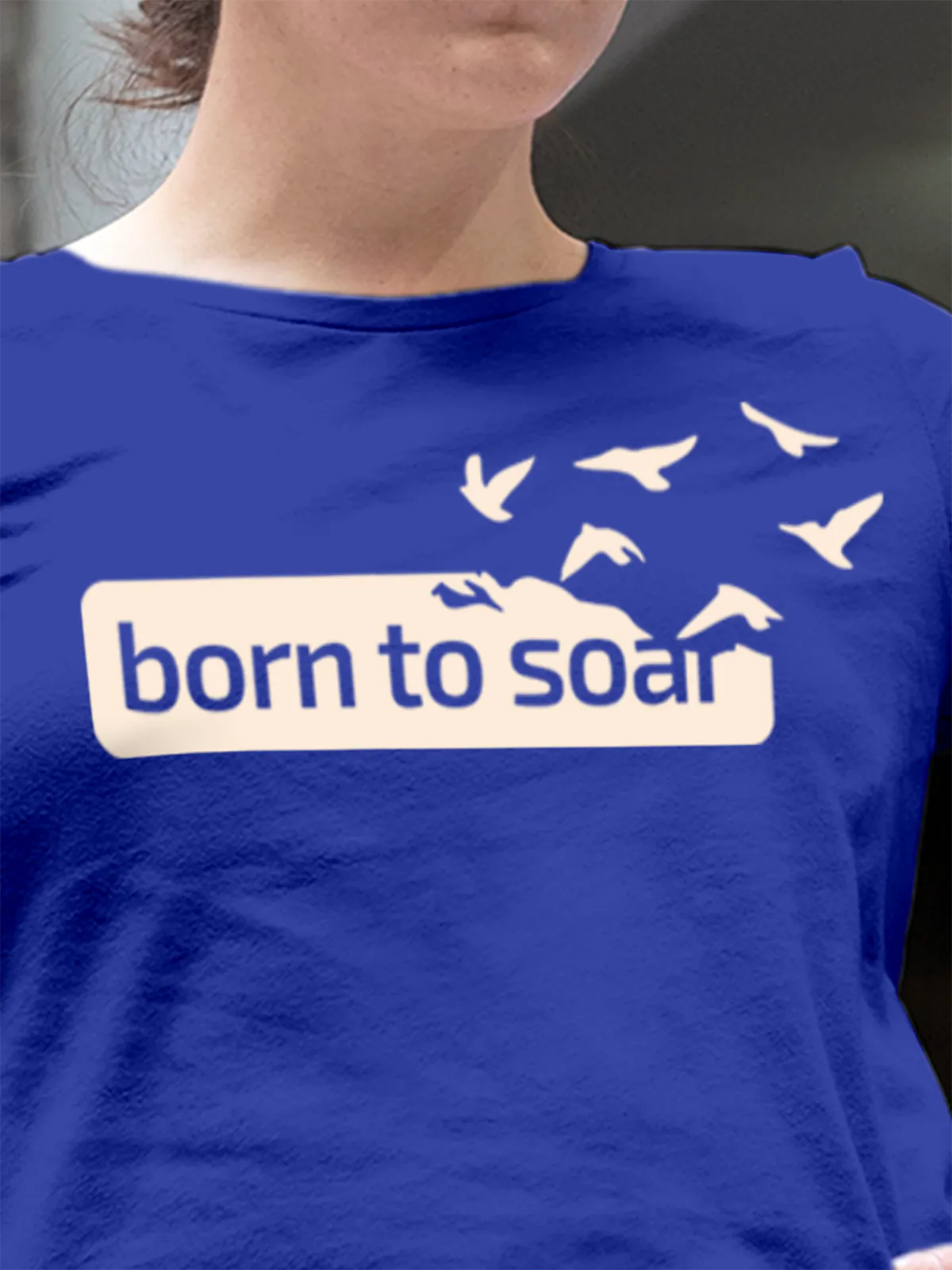Close up of 'Born To Soar' design on Women's Blue Round Neck T-shirt, highlighting intricate details and vibrant print.
