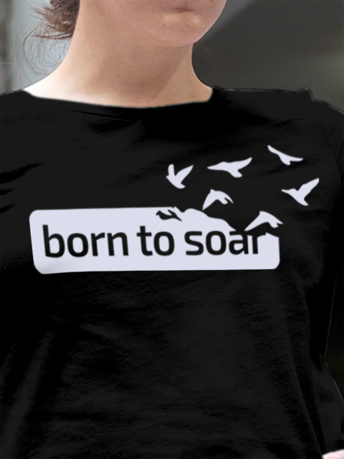 Close up of 'Born To Soar' design on Women's Black Round Neck T-shirt, highlighting intricate details and vibrant print.