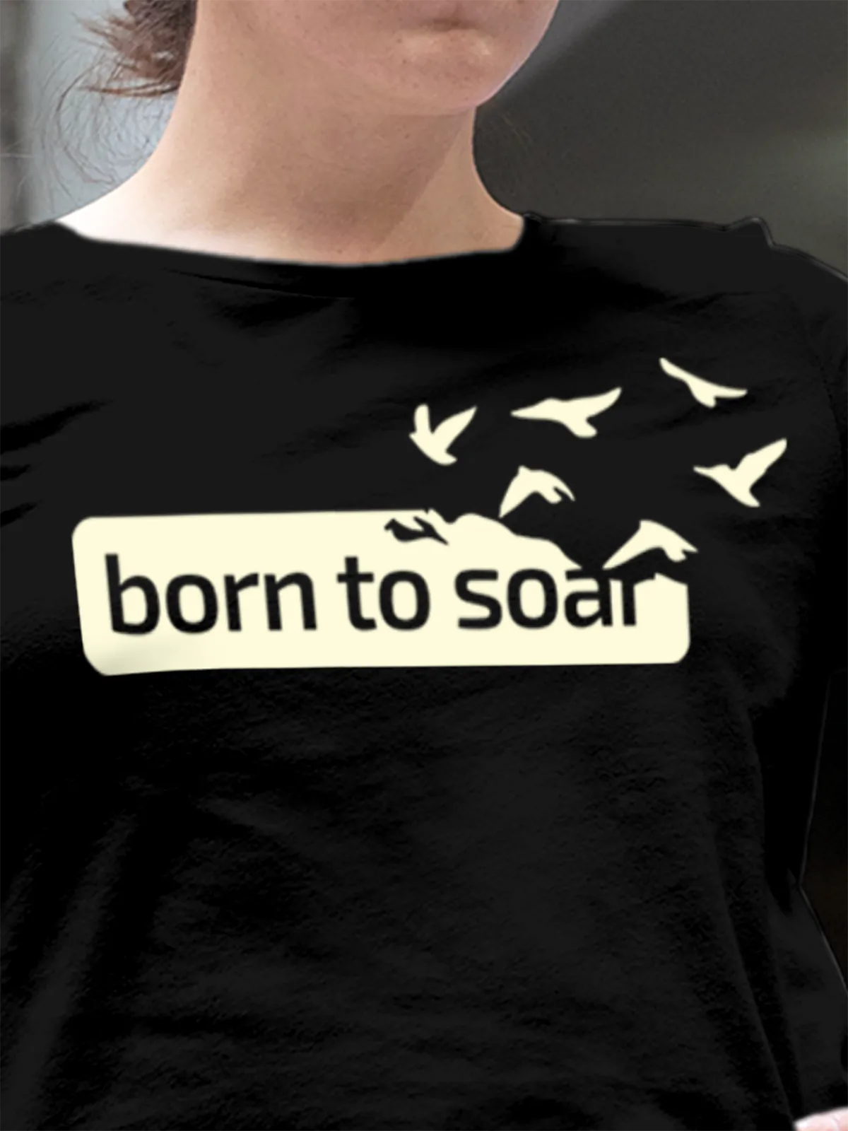Close up of 'Born To Soar' design on Women's Black Round Neck T-shirt, highlighting intricate details and vibrant print.