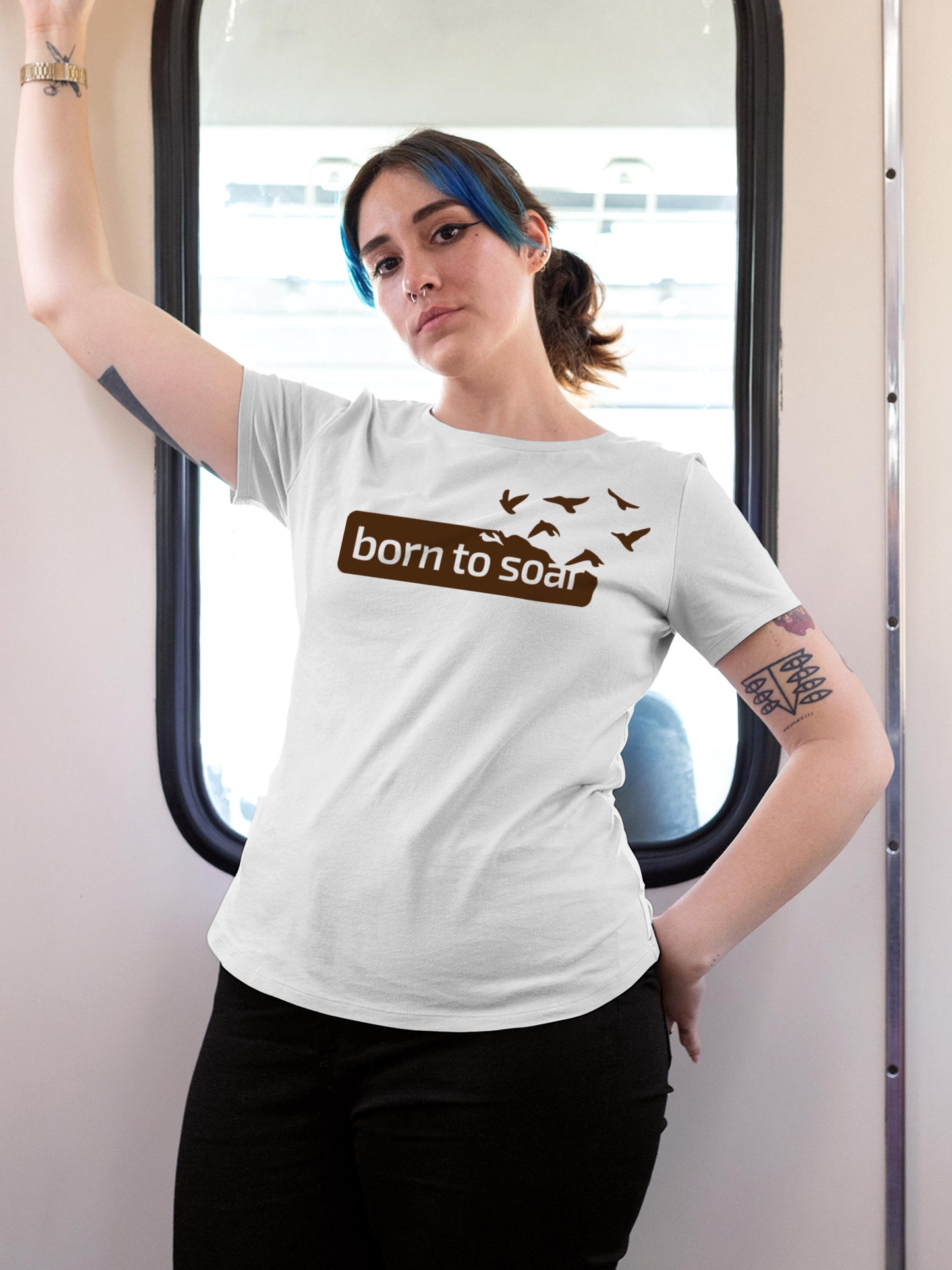 Model wearing Women's White Round Neck T-shirt with 'Born To Soar' design, offering effortless style and premium comfort
