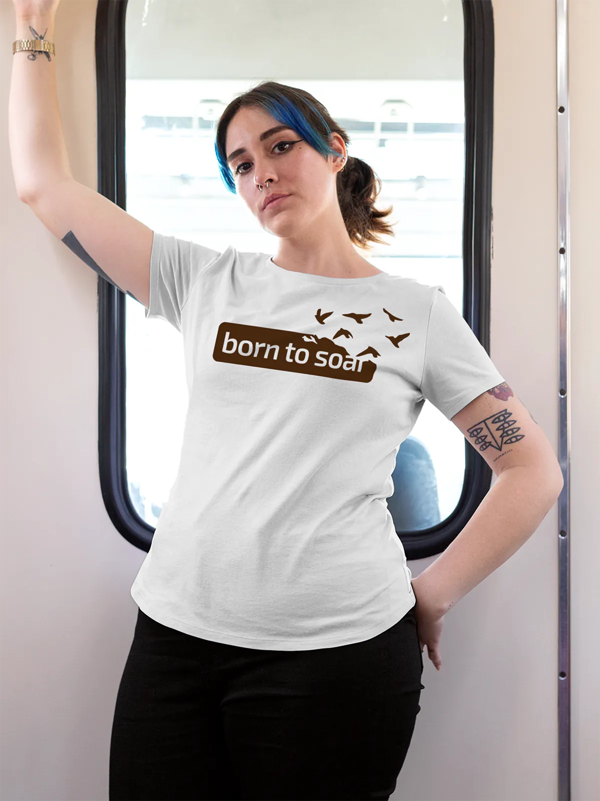 Model wearing Women's White Round Neck T-shirt with 'Born To Soar' design, offering effortless style and premium comfort