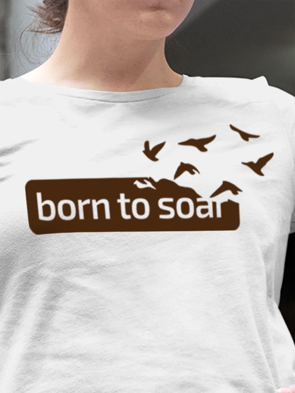 Close up of 'Born To Soar' design on Women's White Round Neck T-shirt, highlighting intricate details and vibrant print.