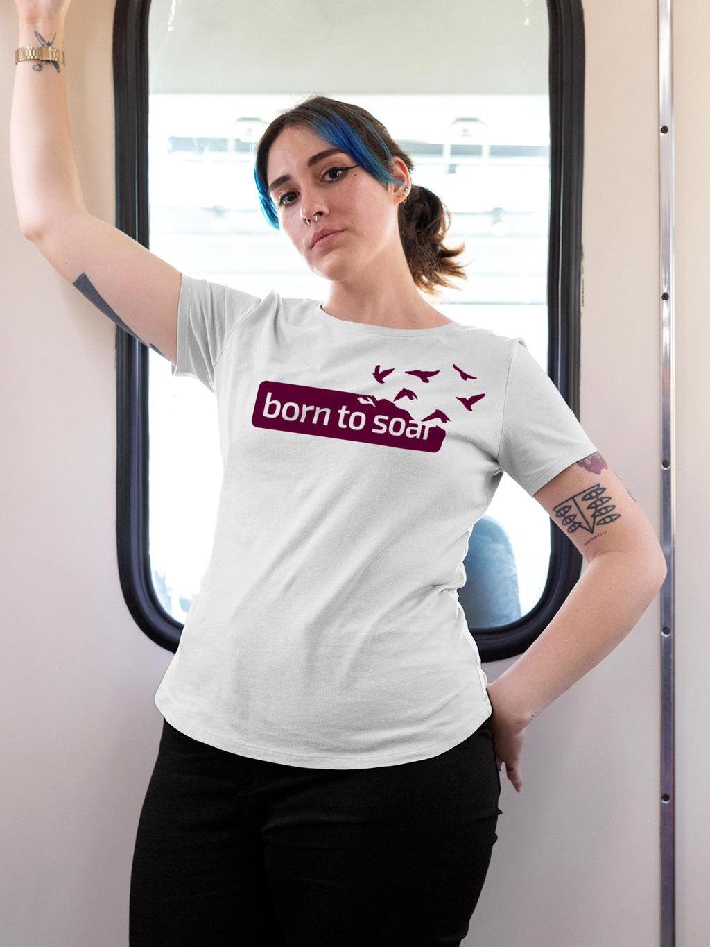 Model wearing Women's White Round Neck T-shirt with 'Born To Soar' design, offering effortless style and premium comfort