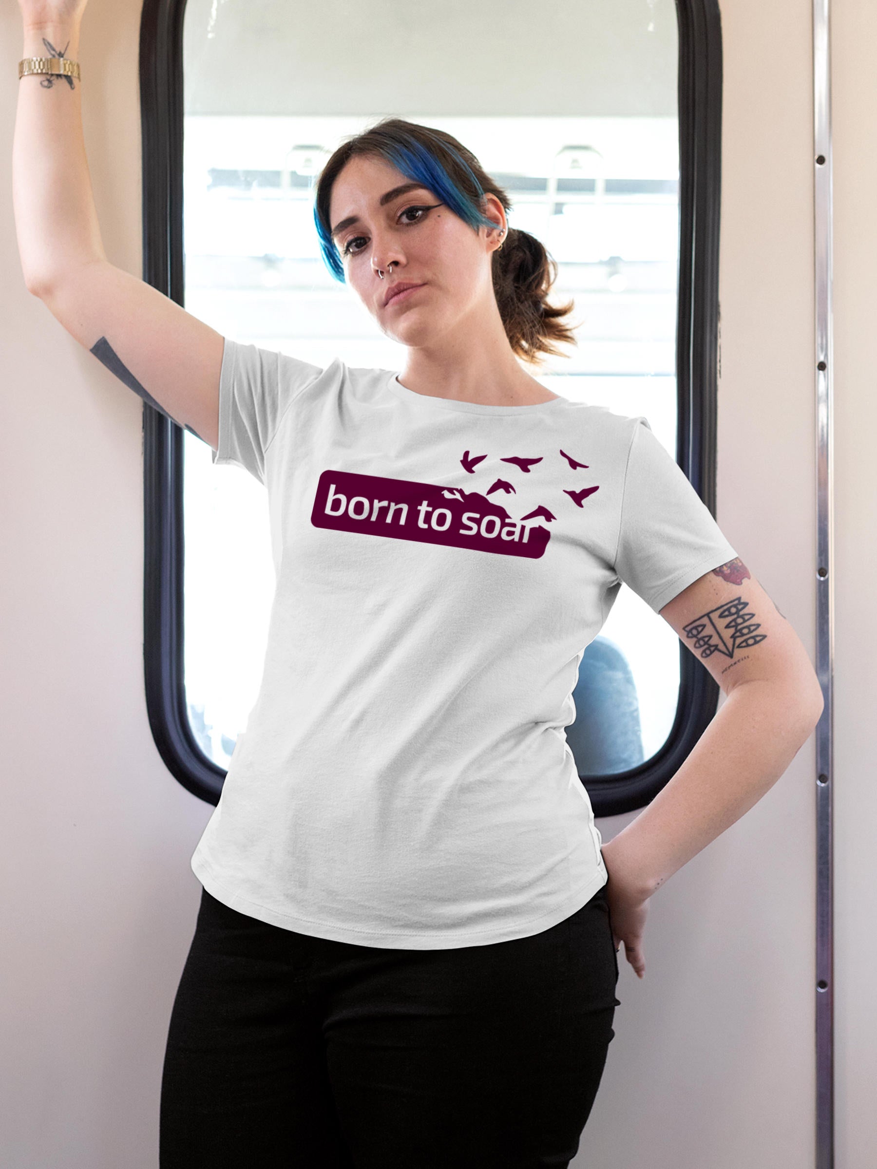 Model wearing Women's White Round Neck T-shirt with 'Born To Soar' design, offering effortless style and premium comfort