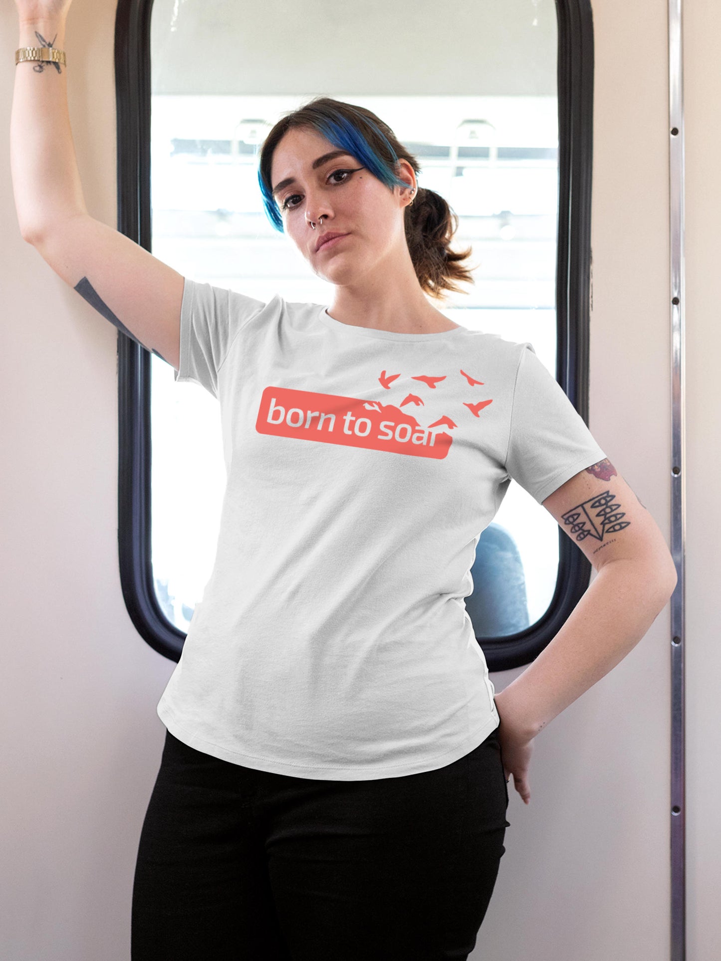 Model wearing Women's White Round Neck T-shirt with 'Born To Soar' design, offering effortless style and premium comfort