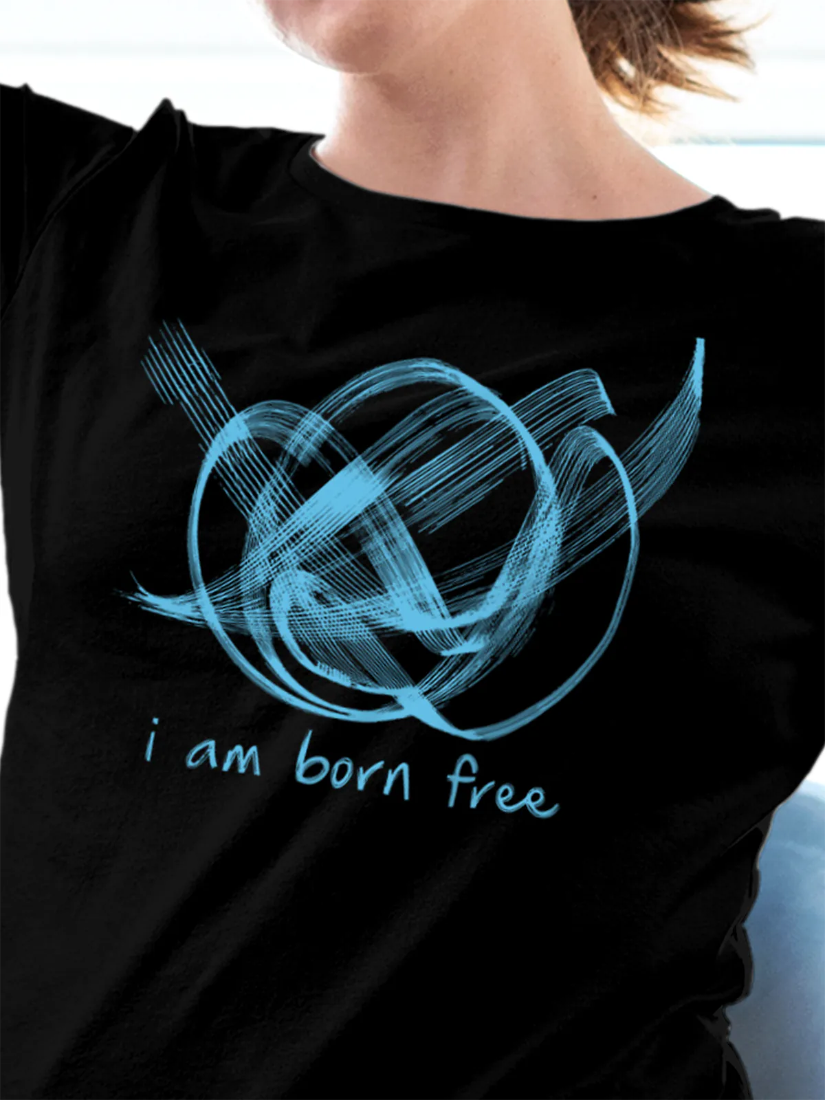Close up of 'Born Free' design on Women's Black Round Neck T-shirt, highlighting intricate details and vibrant print.