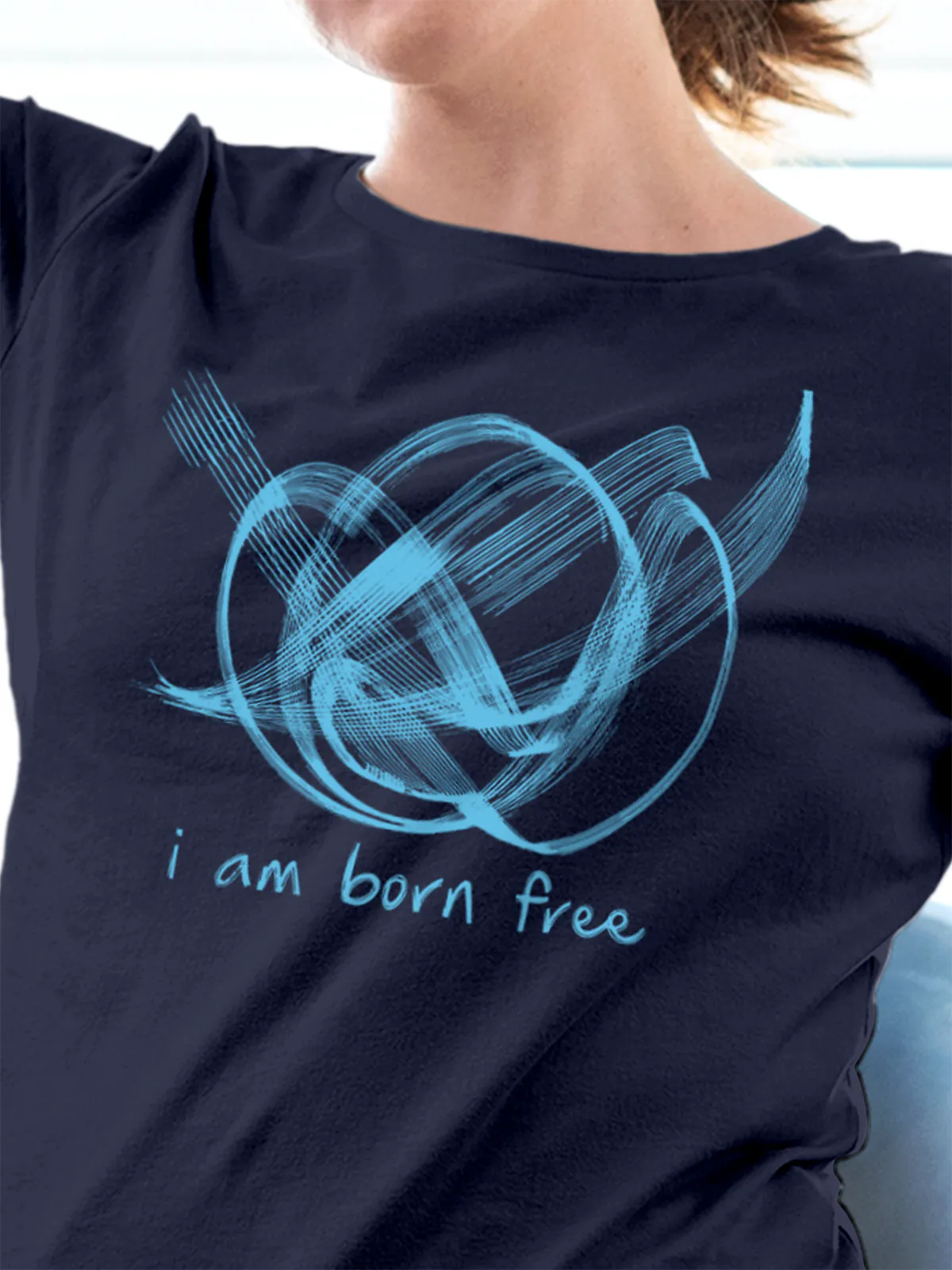 Close up of 'Born Free' design on Women's Navy Blue Round Neck T-shirt, highlighting intricate details and vibrant print.