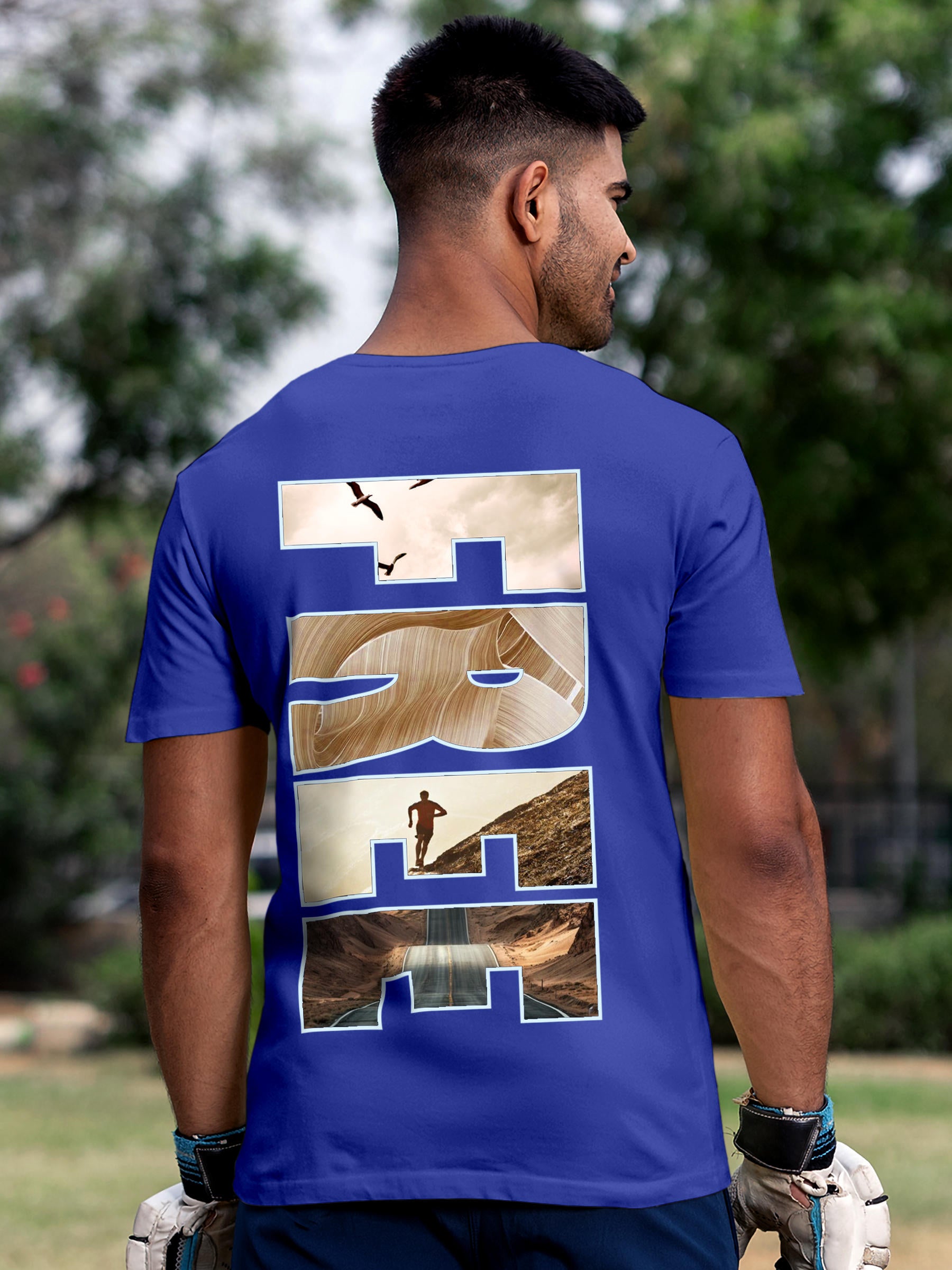 Model wearing Men's Blue Round Neck T-shirt with 'Free & Boundless' design, offering effortless style and premium comfort