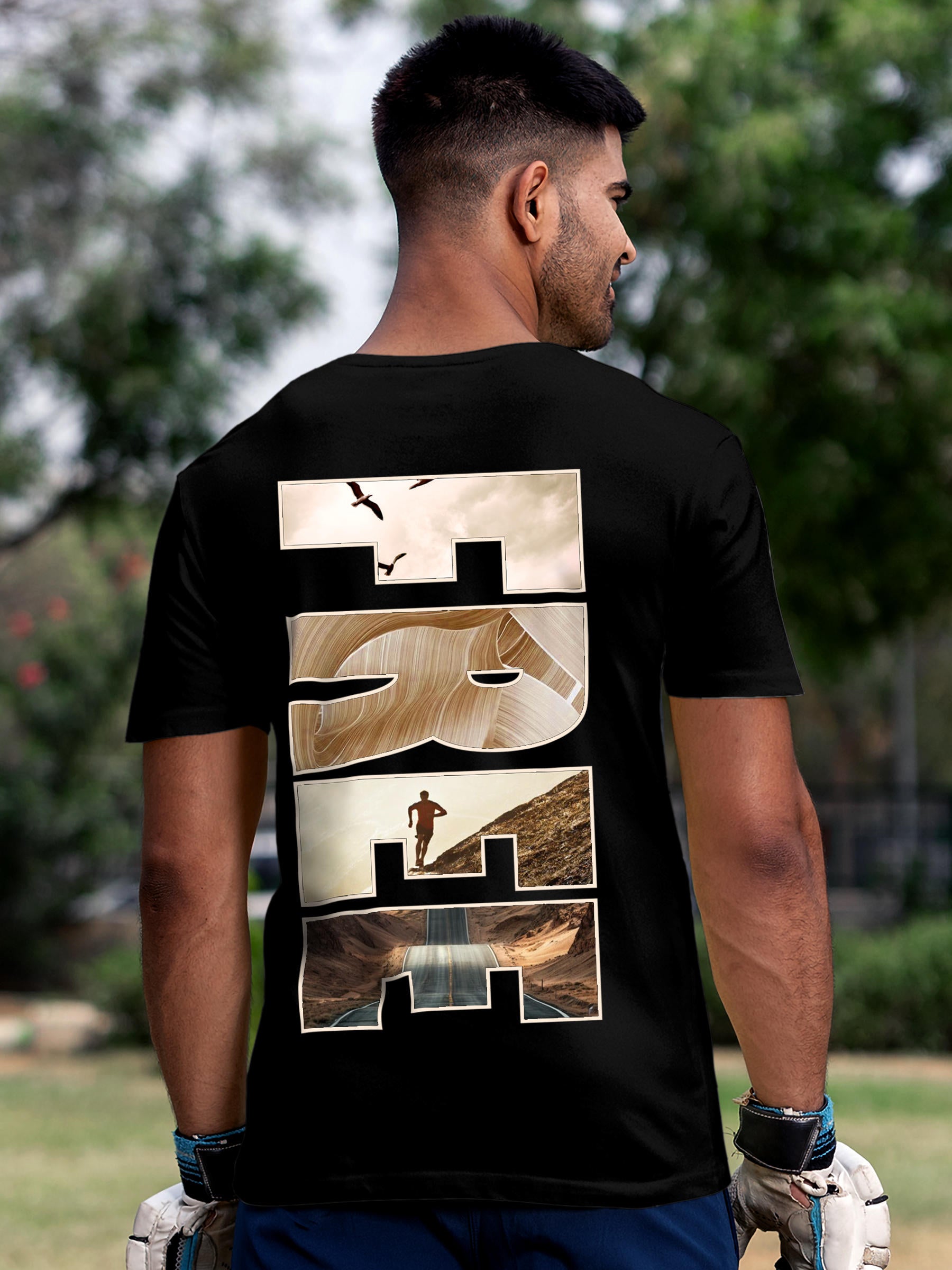 Model wearing Men's Black Round Neck T-shirt with 'Free & Boundless' design, offering effortless style and premium comfort