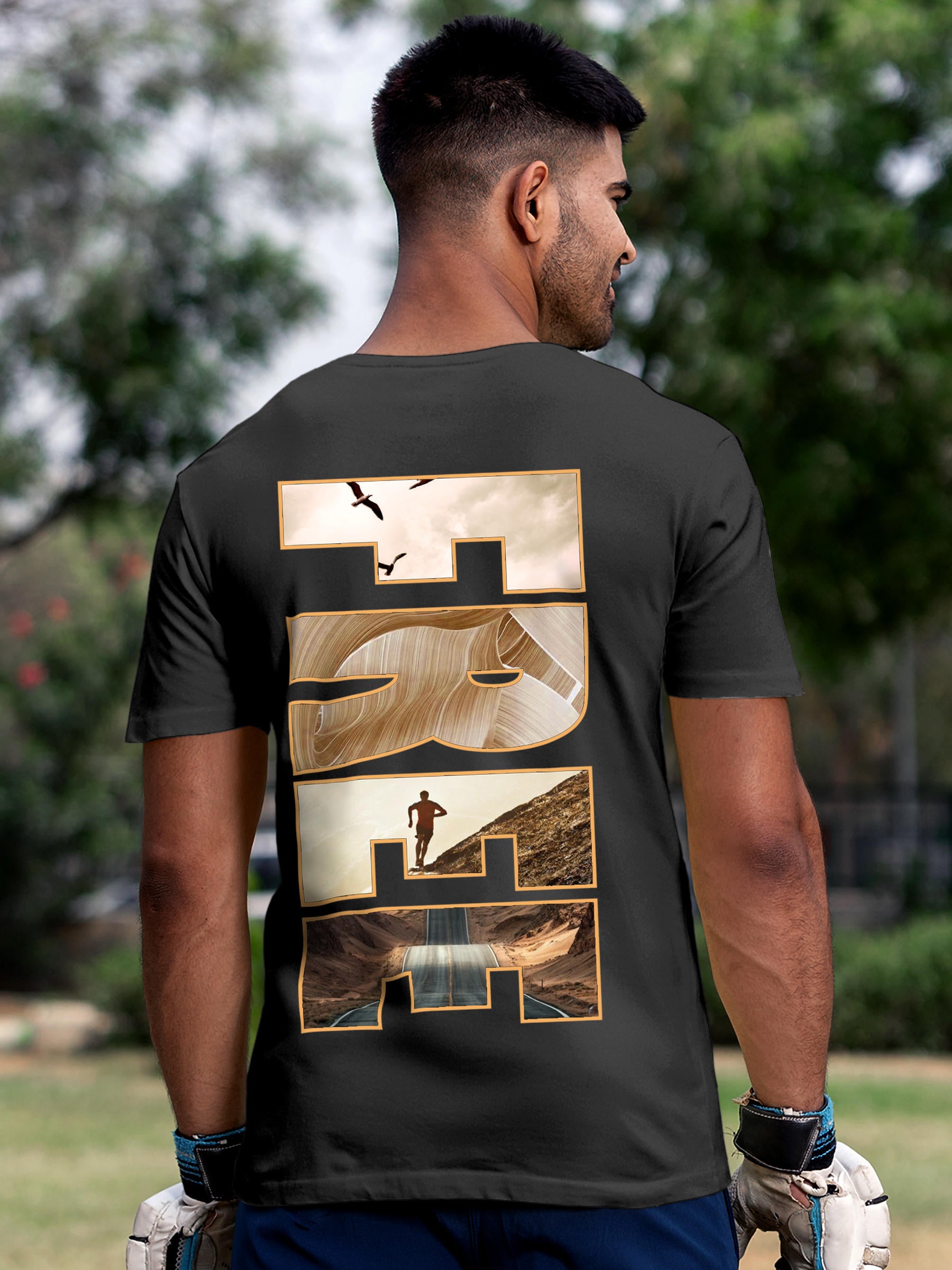 Model wearing Men's Dark Grey Round Neck T-shirt with 'Free & Boundless' design, offering effortless style and premium comfort