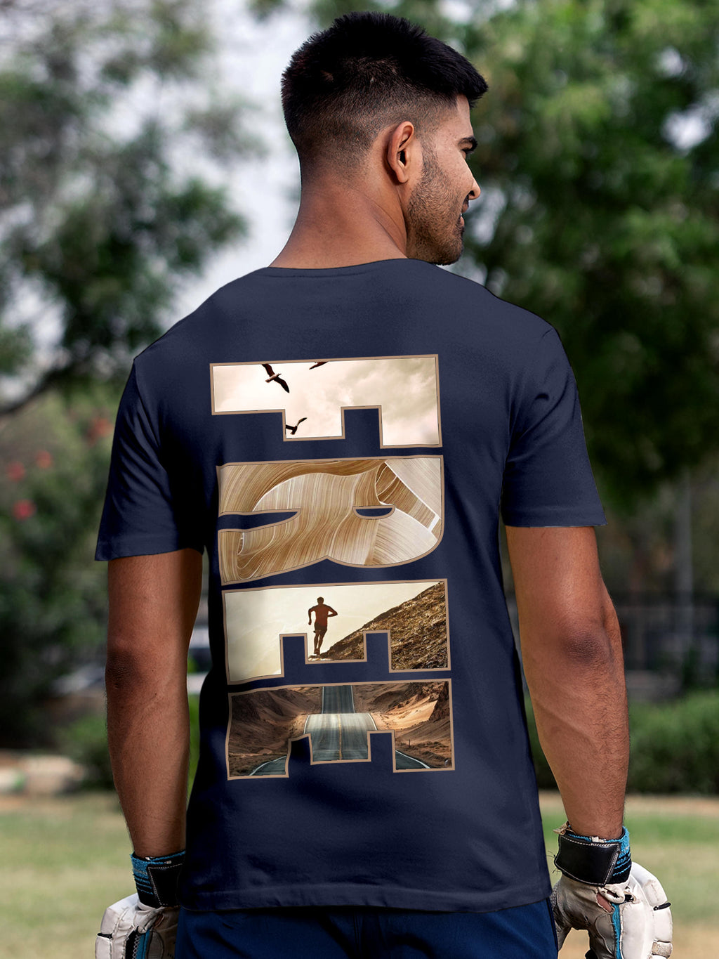 Model wearing Men's Navy Blue Round Neck T-shirt with 'Free & Boundless' design, offering effortless style and premium comfort