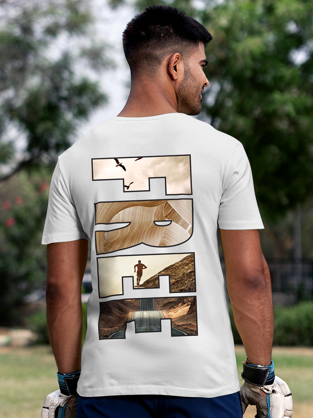 Model wearing Men's White Round Neck T-shirt with 'Free & Boundless' design, offering effortless style and premium comfort