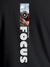 Close up of 'Focus' design on Women's Dark Grey Round Neck T-shirt, highlighting intricate details and vibrant print.