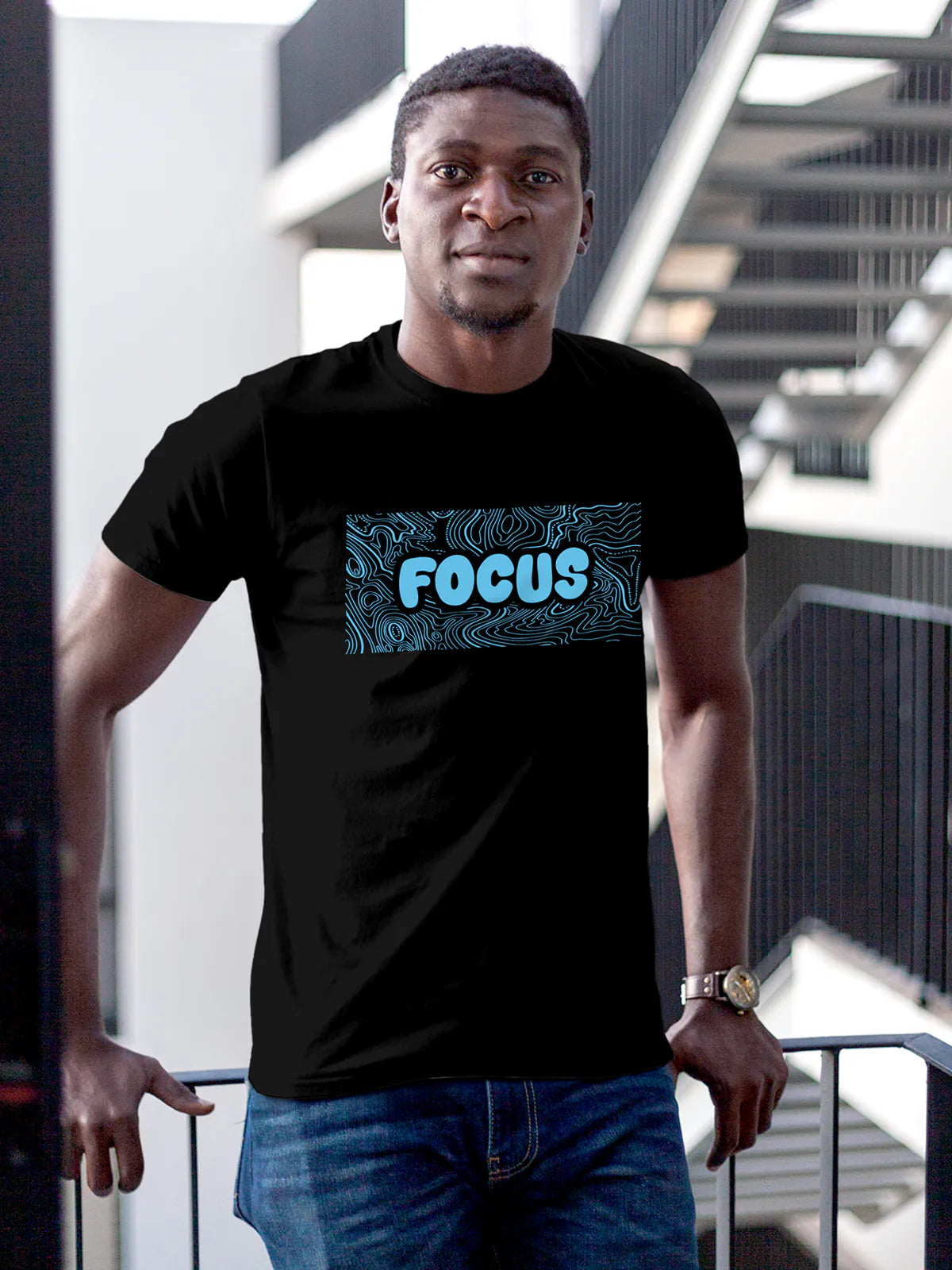 Model wearing Men's Black Round Neck T-shirt with 'Focus In Chaos' design, offering effortless style and premium comfort