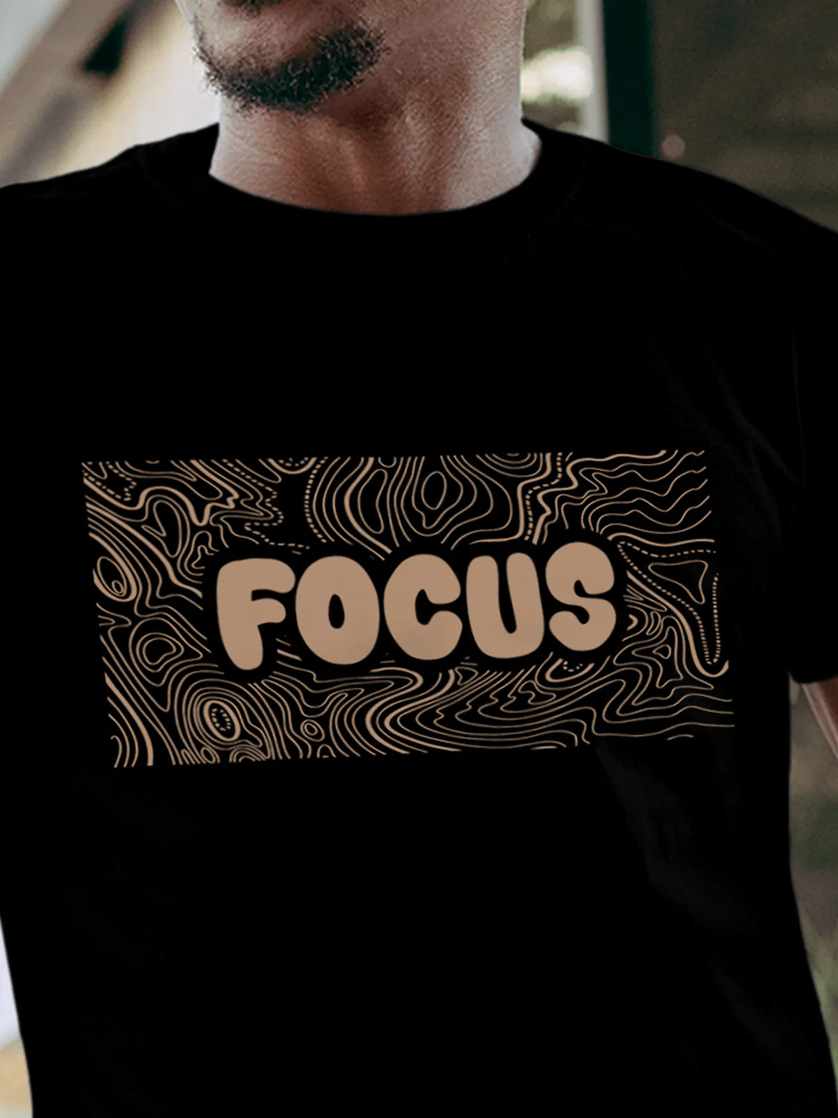 Close up of 'Focus In Chaos' design on Men's Black Round Neck T-shirt, highlighting intricate details and vibrant print.