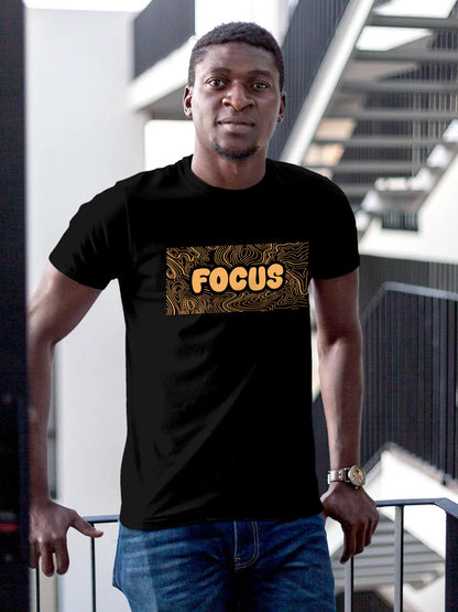 Model wearing Men's Black Round Neck T-shirt with 'Focus In Chaos' design, offering effortless style and premium comfort