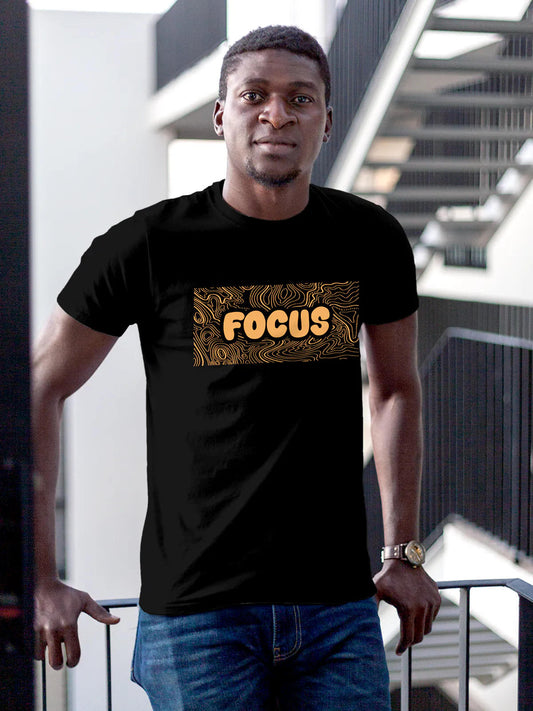 Model wearing Men's Black Round Neck T-shirt with 'Focus In Chaos' design, offering effortless style and premium comfort