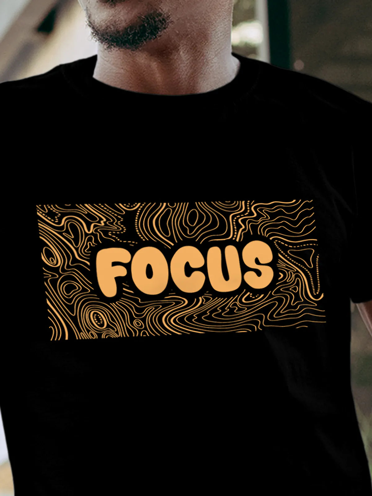 Close up of 'Focus In Chaos' design on Men's Black Round Neck T-shirt, highlighting intricate details and vibrant print.
