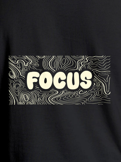 Close up of 'Focus In Chaos' design on Men's Dark Grey Round Neck T-shirt, highlighting intricate details and vibrant print.