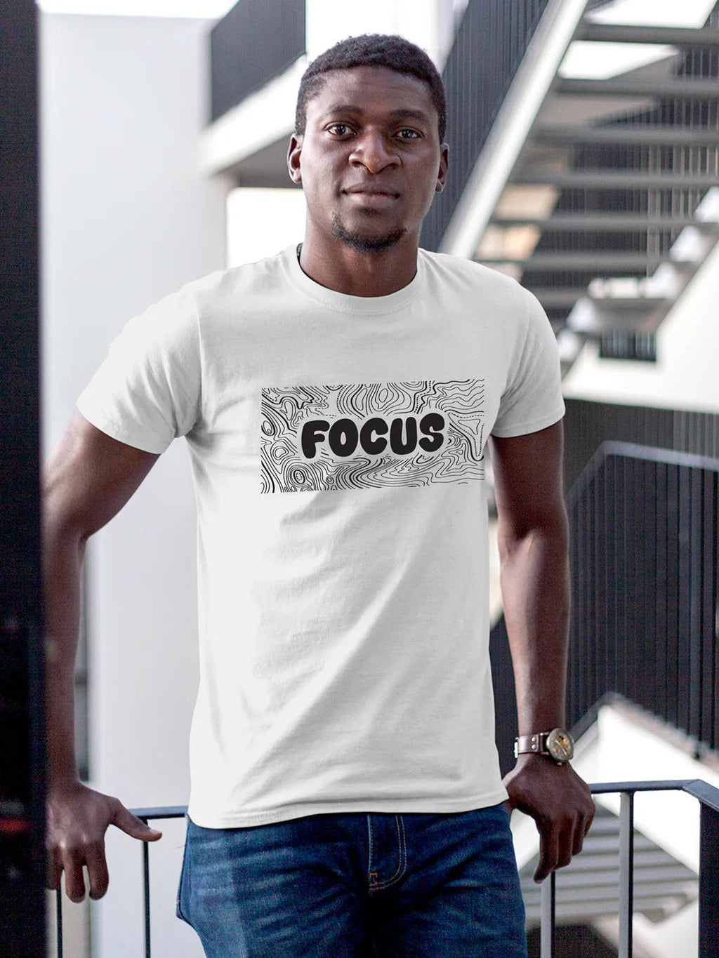 Model wearing Men's White Round Neck T-shirt with 'Focus In Chaos' design, offering effortless style and premium comfort