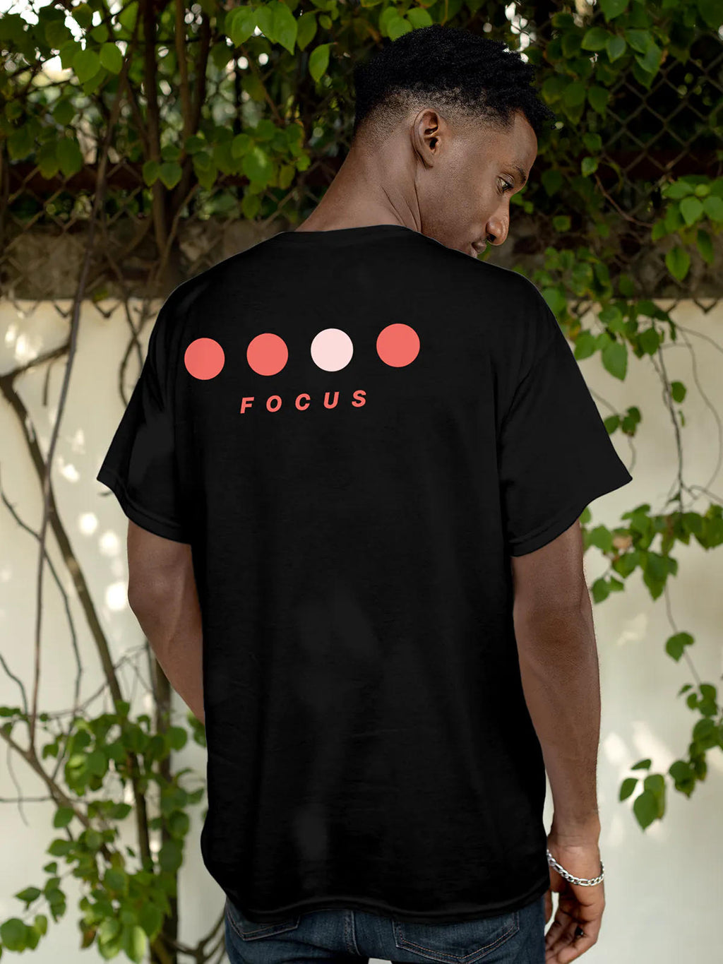 Model wearing Men's Black Round Neck T-shirt with 'Focus On Goal' design, offering effortless style and premium comfort