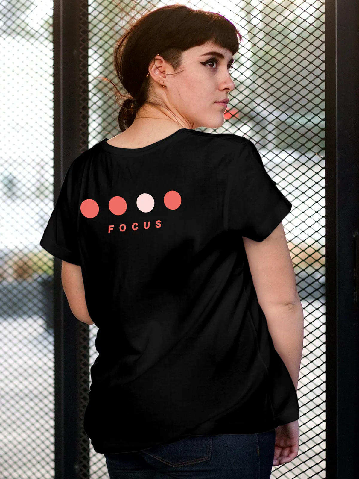 Model wearing Women's Black Round Neck T-shirt with 'Focus On Goal' design, offering effortless style and premium comfort