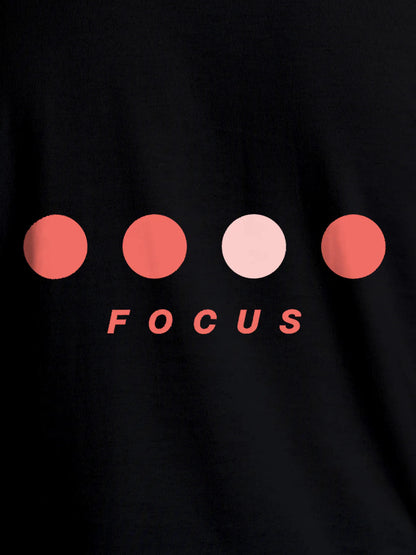 Close up of 'Focus On Goal' design on Women's Black Round Neck T-shirt, highlighting intricate details and vibrant print.
