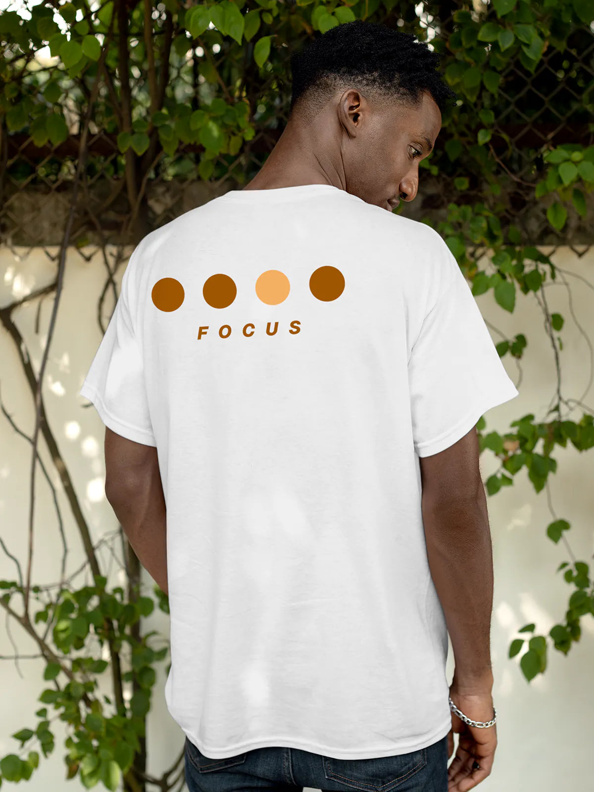 Model wearing Men's White Round Neck T-shirt with 'Focus On Goal' design, offering effortless style and premium comfort