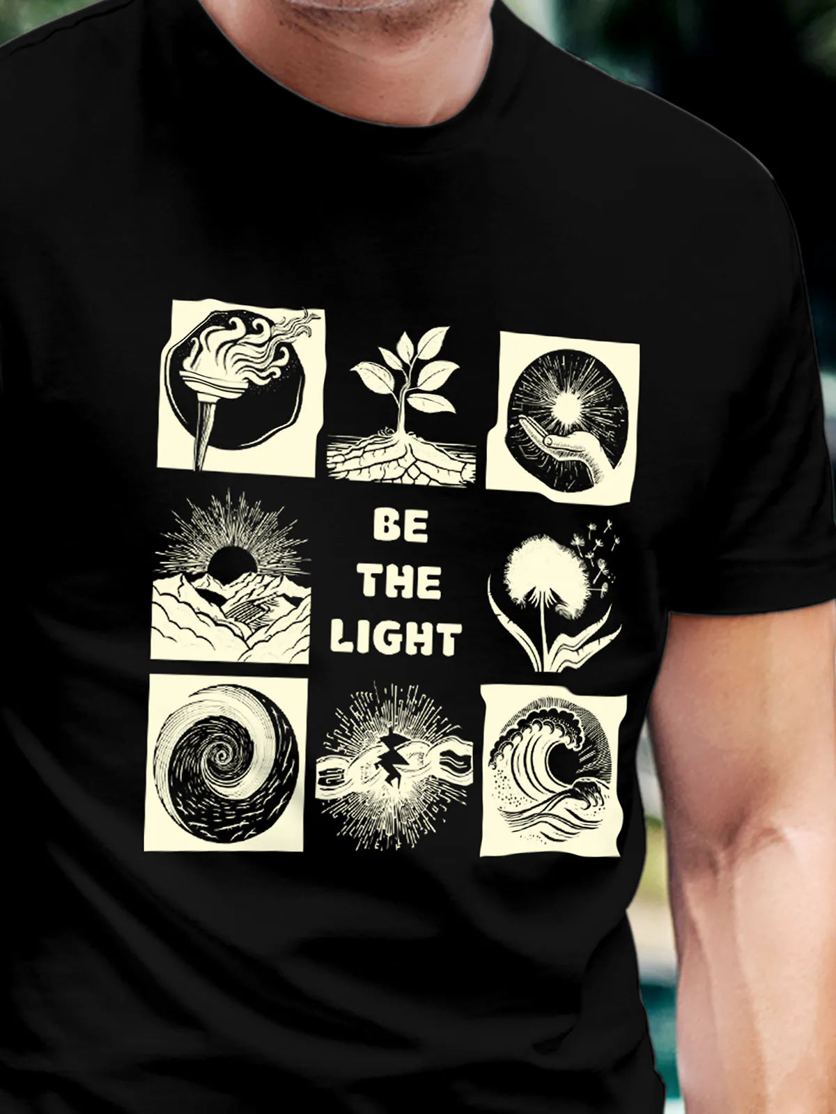Close up of 'Be The Light' design on Men's Black Round Neck T-shirt, highlighting intricate details and vibrant print.