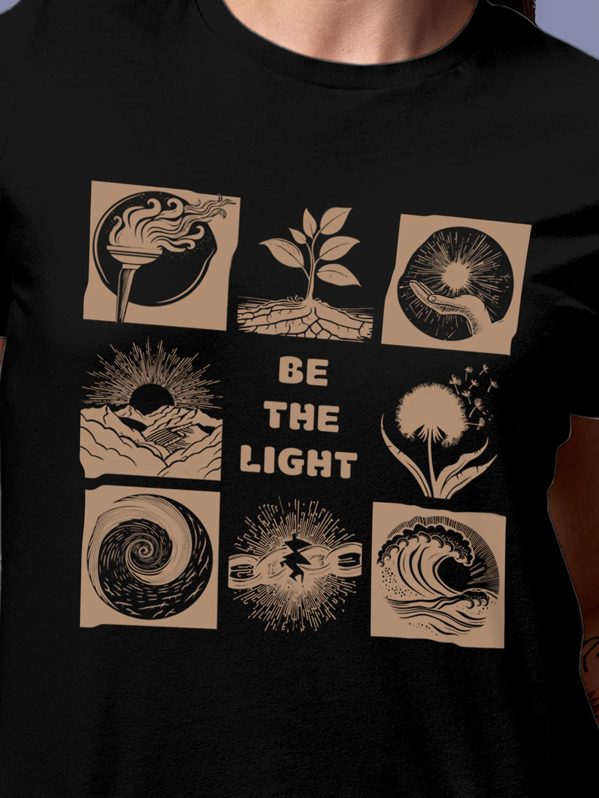 Close up of 'Be The Light' design on Women's Black Round Neck T-shirt, highlighting intricate details and vibrant print.
