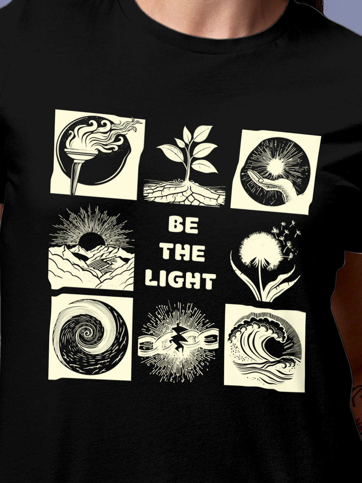 Close up of 'Be The Light' design on Women's Black Round Neck T-shirt, highlighting intricate details and vibrant print.