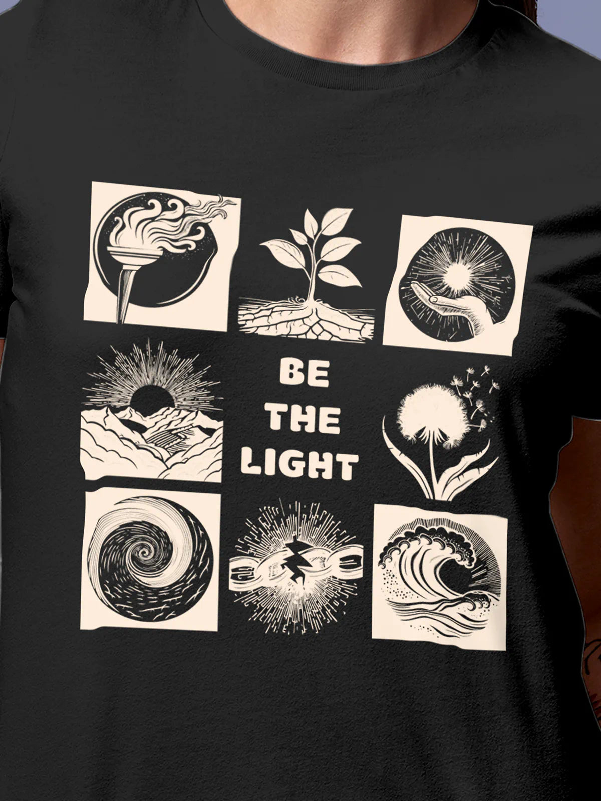 Close up of 'Be The Light' design on Women's Dark Grey Round Neck T-shirt, highlighting intricate details and vibrant print.