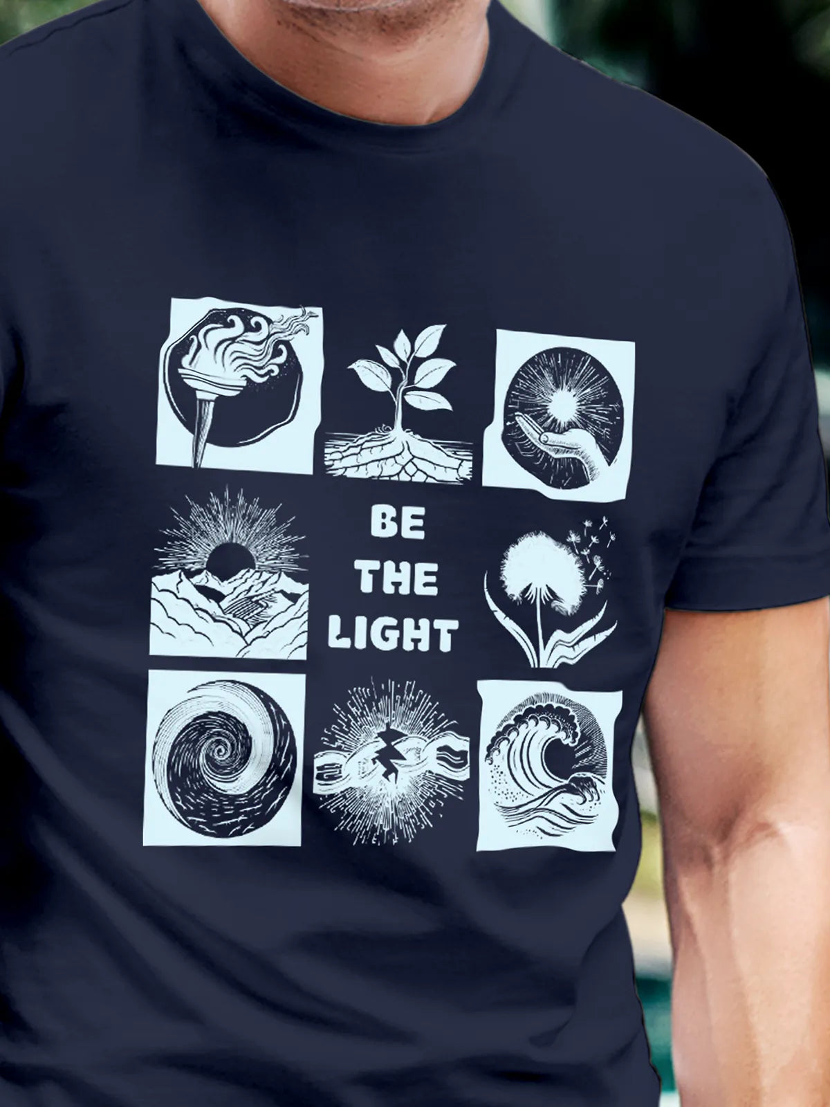 Close up of 'Be The Light' design on Men's Navy Blue Round Neck T-shirt, highlighting intricate details and vibrant print.
