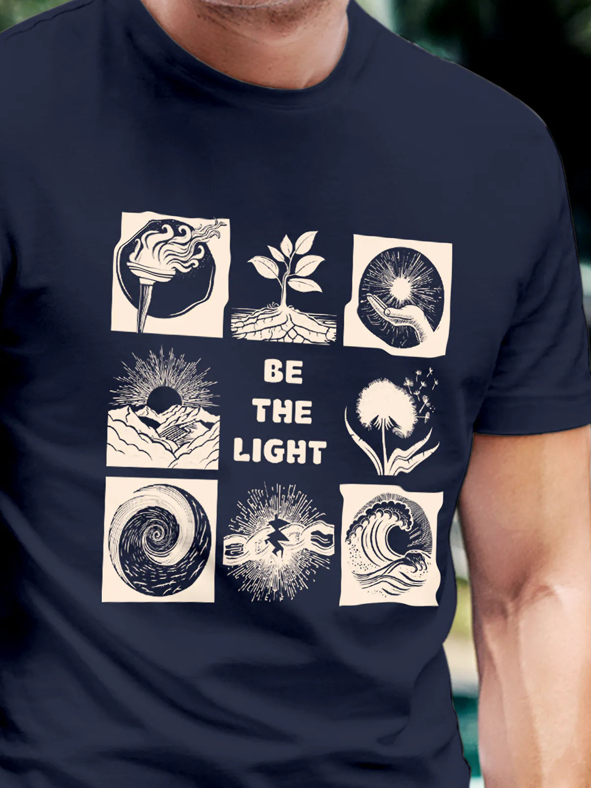 Close up of 'Be The Light' design on Men's Navy Blue Round Neck T-shirt, highlighting intricate details and vibrant print.