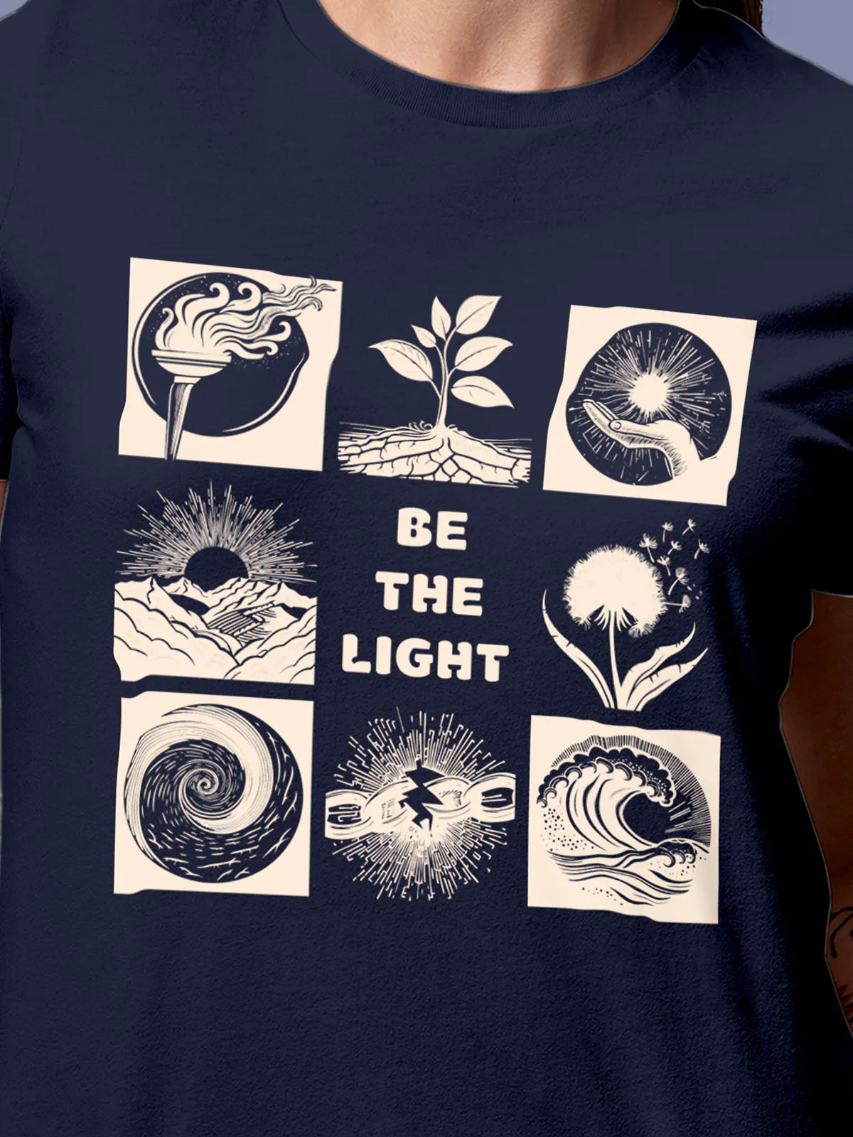 Close up of 'Be The Light' design on Women's Navy Blue Round Neck T-shirt, highlighting intricate details and vibrant print.