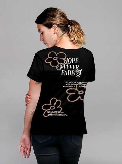 Model wearing Women's Black Round Neck T-shirt with 'Hope Never Fades' design, offering effortless style and premium comfort