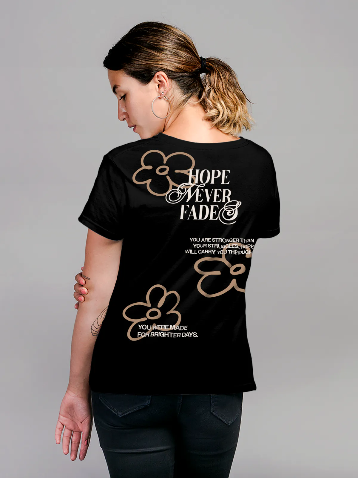 Model wearing Women's Black Round Neck T-shirt with 'Hope Never Fades' design, offering effortless style and premium comfort
