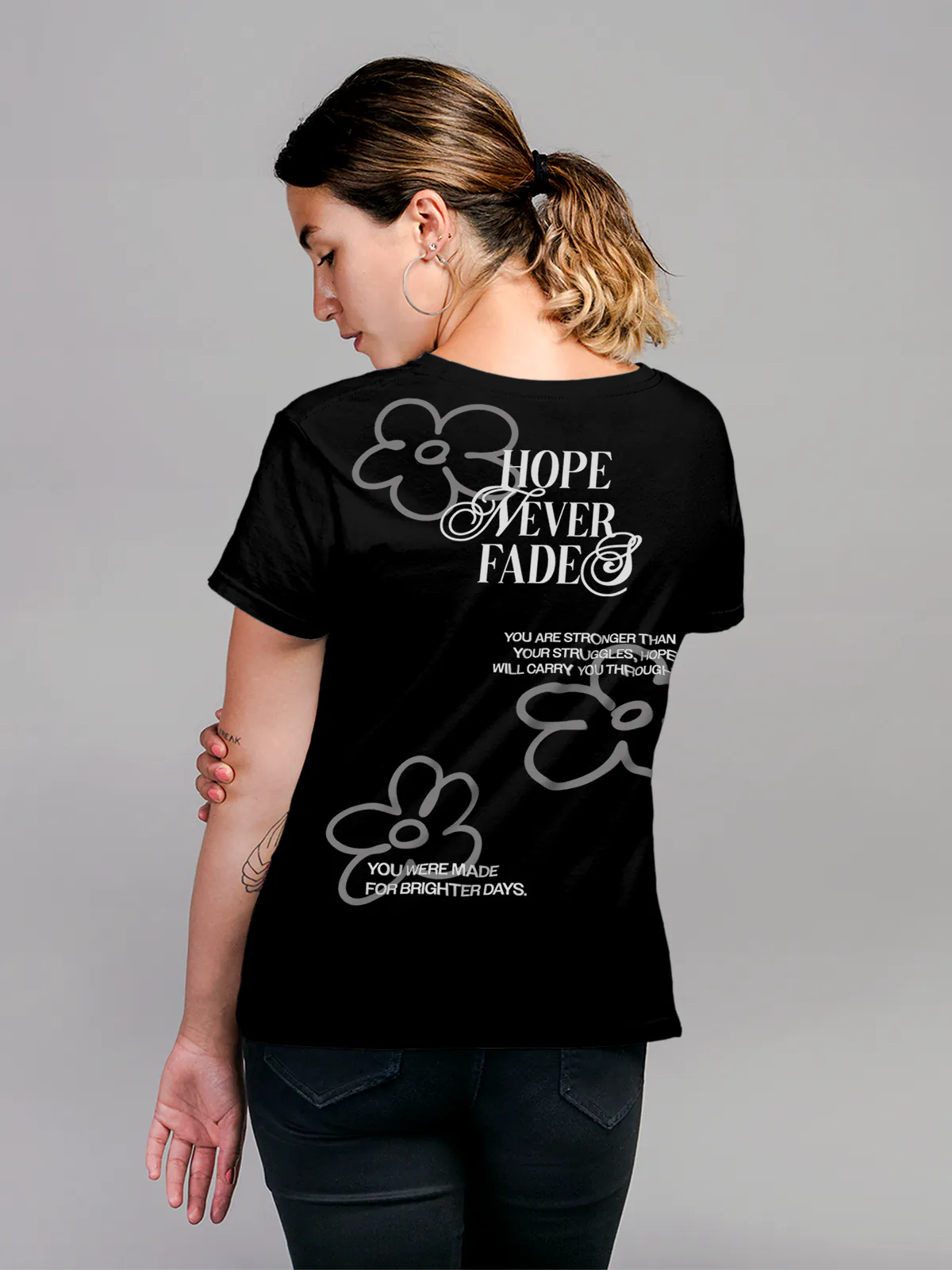 Model wearing Women's Black Round Neck T-shirt with 'Hope Never Fades' design, offering effortless style and premium comfort