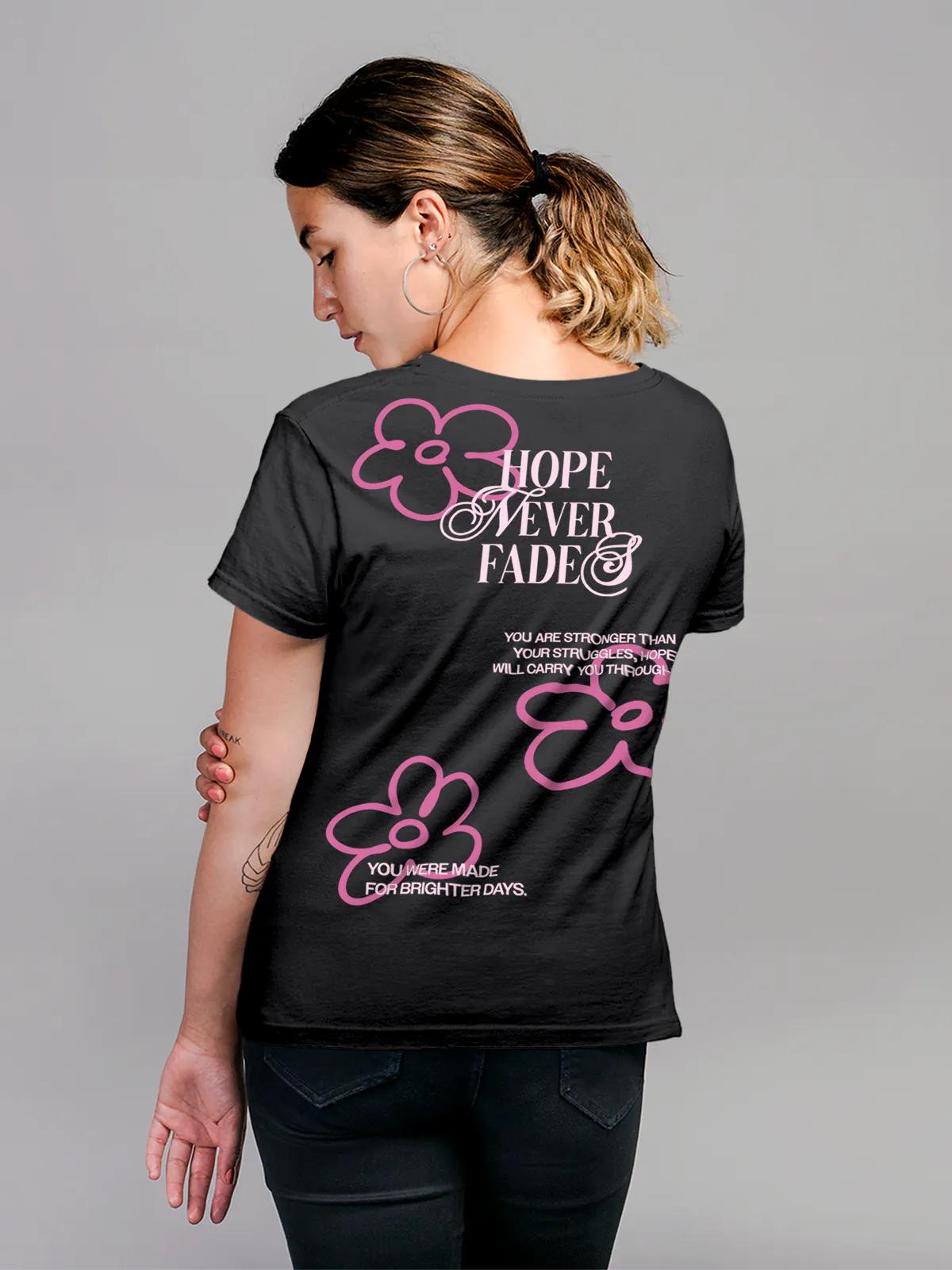Model wearing Women's Dark Grey Round Neck T-shirt with 'Hope Never Fades' design, offering effortless style and premium comfort