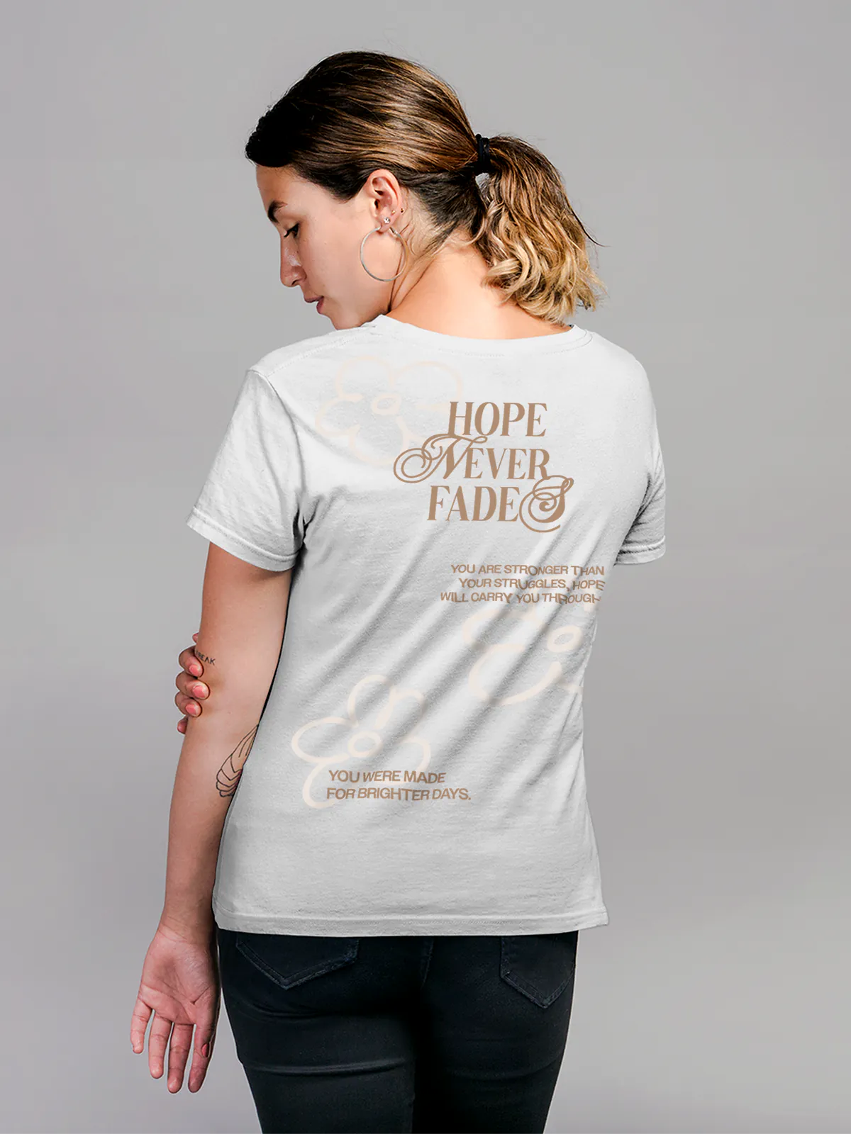 Model wearing Women's White Round Neck T-shirt with 'Hope Never Fades' design, offering effortless style and premium comfort