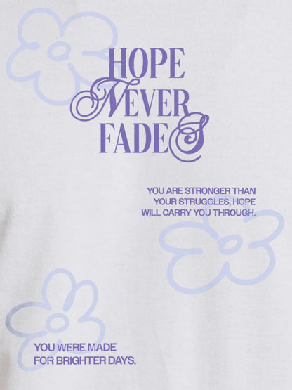 Close up of 'Hope Never Fades' design on Women's White Round Neck T-shirt, highlighting intricate details and vibrant print.