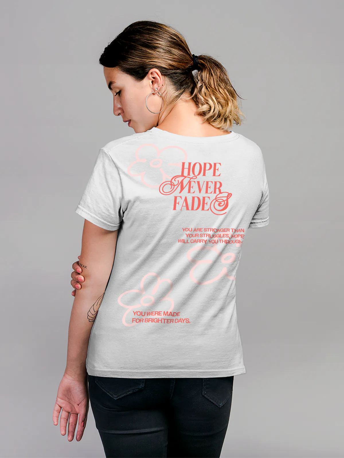 Model wearing Women's White Round Neck T-shirt with 'Hope Never Fades' design, offering effortless style and premium comfort