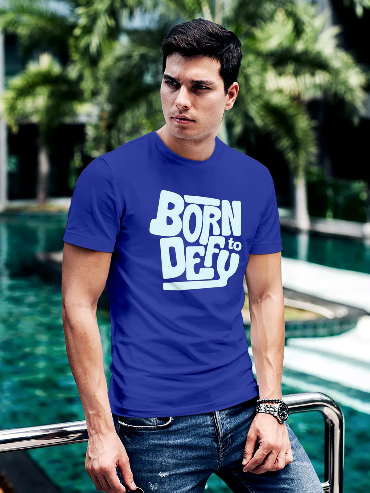 Model wearing Men's Blue Round Neck T-shirt with 'Born To Defy' design, offering effortless style and premium comfort