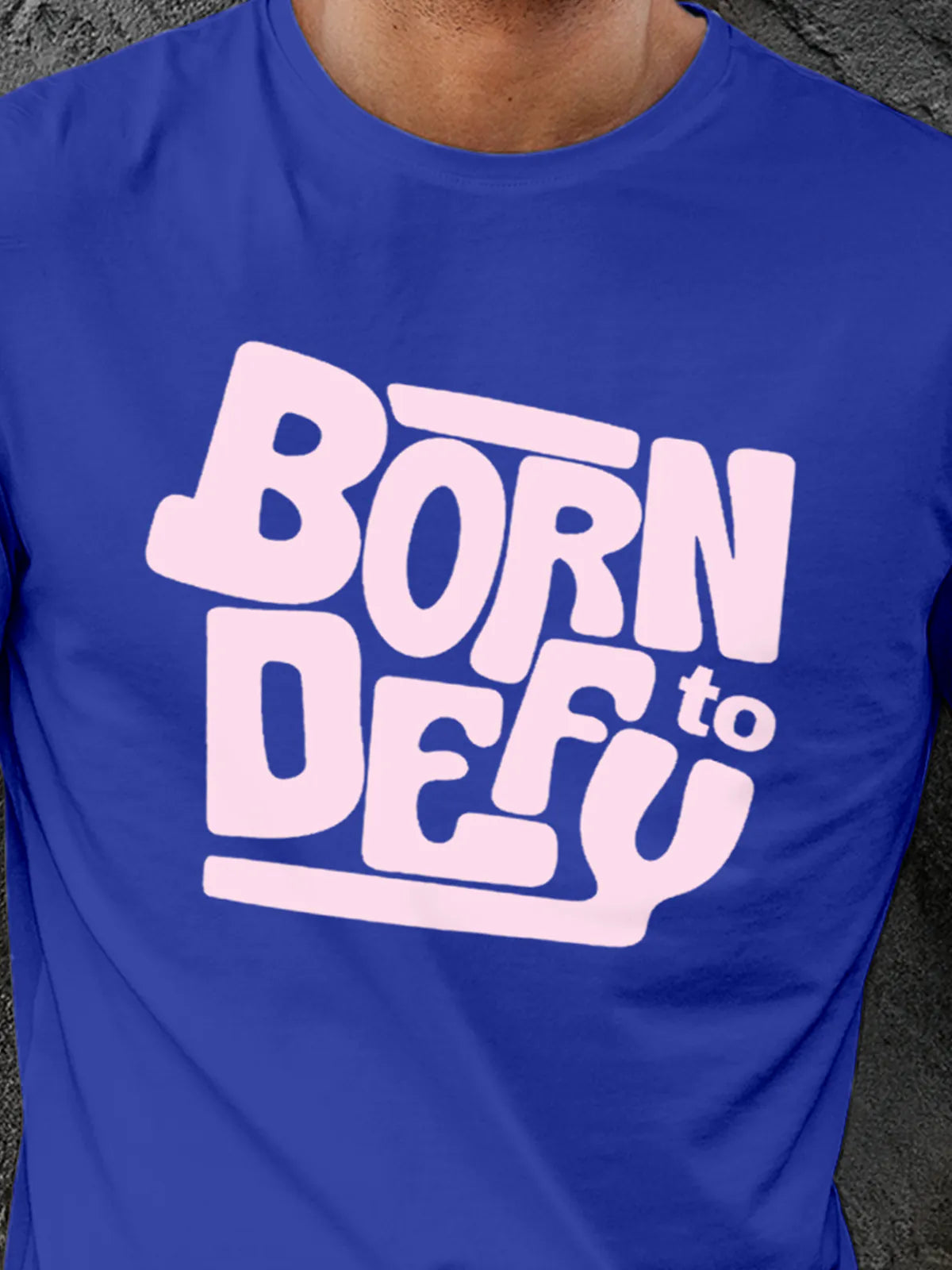 Close up of 'Born To Defy' design on Men's Blue Round Neck T-shirt, highlighting intricate details and vibrant print.