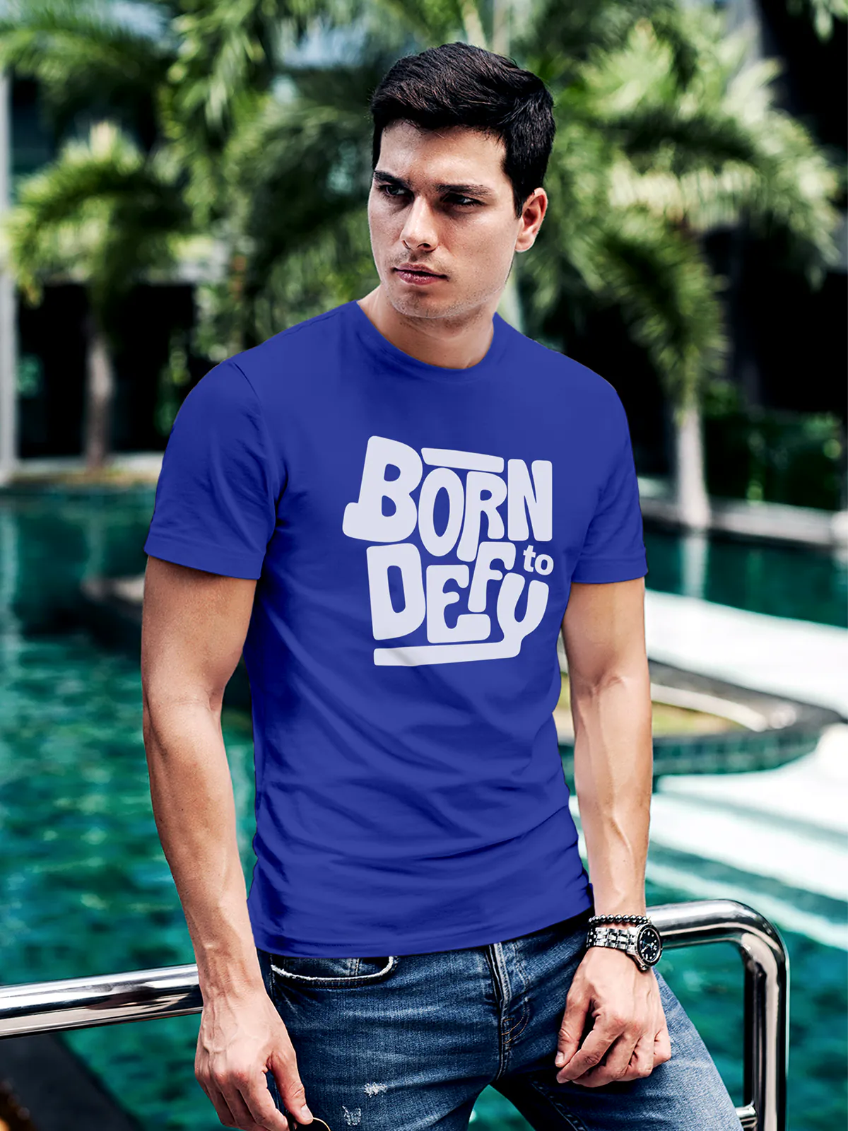 Model wearing Men's Blue Round Neck T-shirt with 'Born To Defy' design, offering effortless style and premium comfort