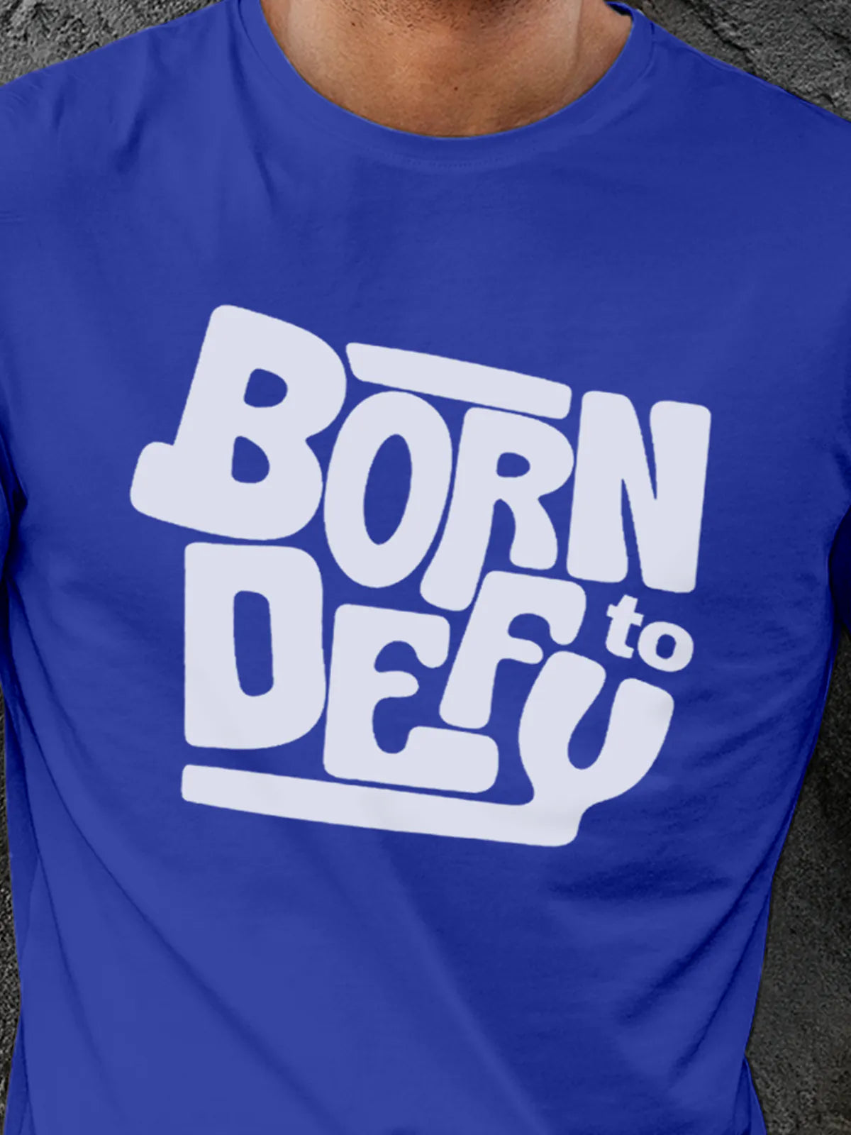 Close up of 'Born To Defy' design on Men's Blue Round Neck T-shirt, highlighting intricate details and vibrant print.
