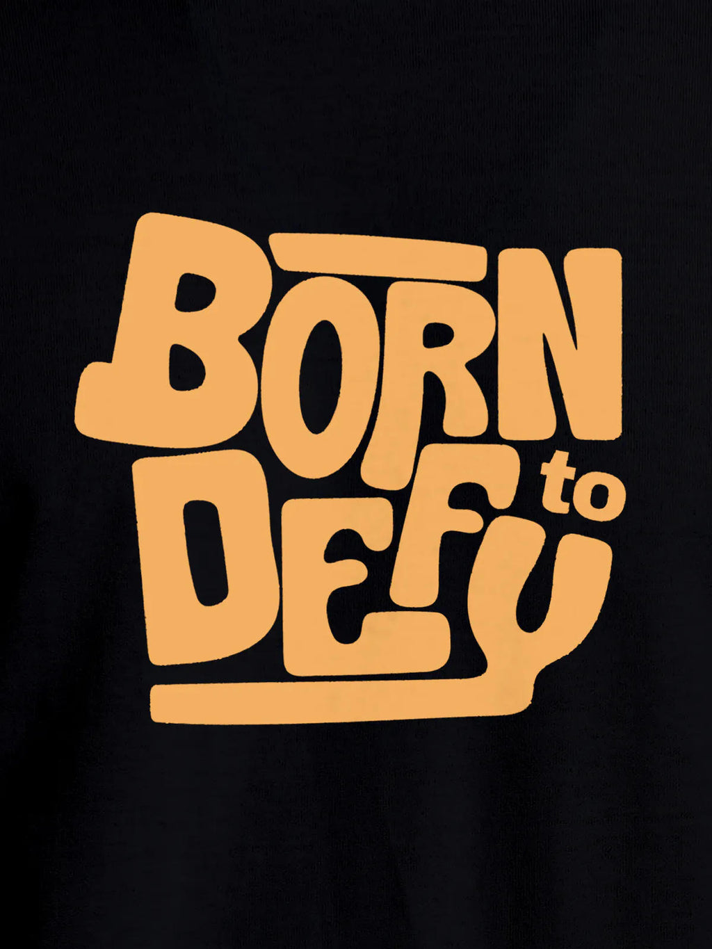 Close up of 'Born To Defy' design on Men's Black Round Neck T-shirt, highlighting intricate details and vibrant print.