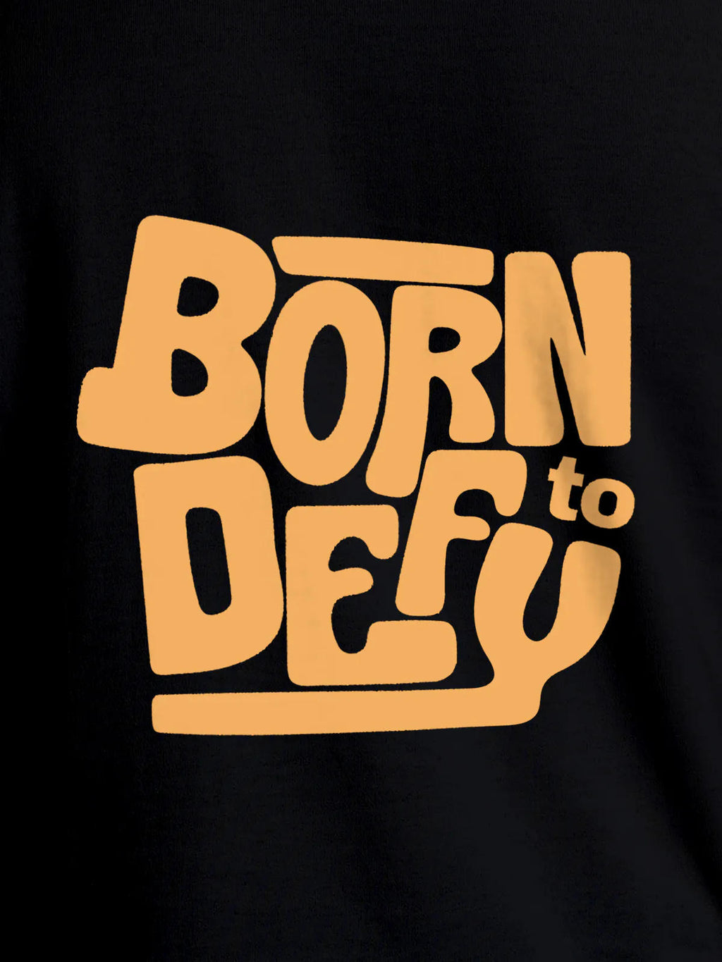 Close up of 'Born To Defy' design on Women's Black Round Neck T-shirt, highlighting intricate details and vibrant print.
