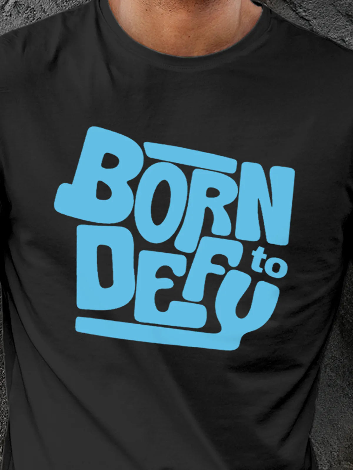 Close up of 'Born To Defy' design on Men's Dark Grey Round Neck T-shirt, highlighting intricate details and vibrant print.